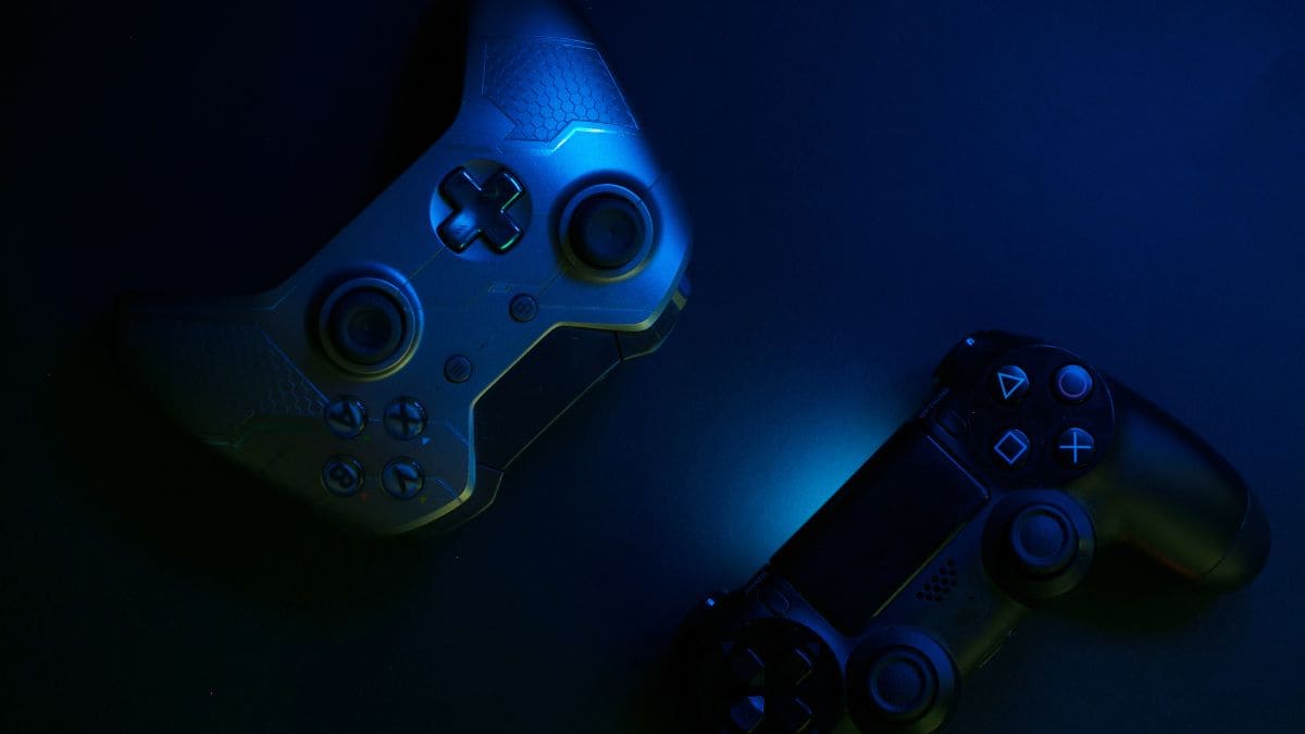 Futuristic Blue‑lit Gaming Controllers on a Dark Background